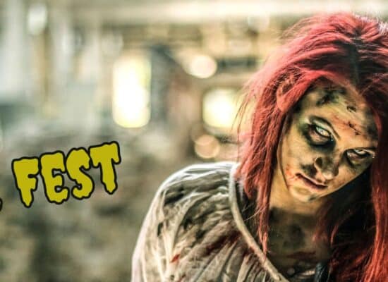 zombie with red hair in front of blurred city background with text “zombie fest”